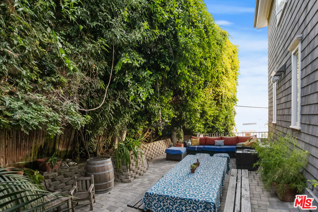 2962 Valmere Drive Malibu, CA 90265 - Photo 19 of 42 a view of a patio with table and chairs and potted plants