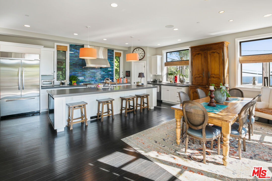 2962 Valmere Drive Malibu, CA 90265 - Photo 2 of 42 a dining room with wooden floor and large windows