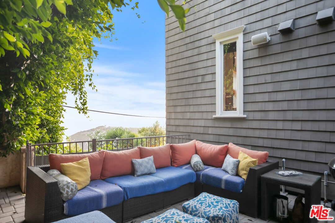 2962 Valmere Drive Malibu, CA 90265 - Photo 21 of 42 a view of a patio with couches chairs and a potted plant