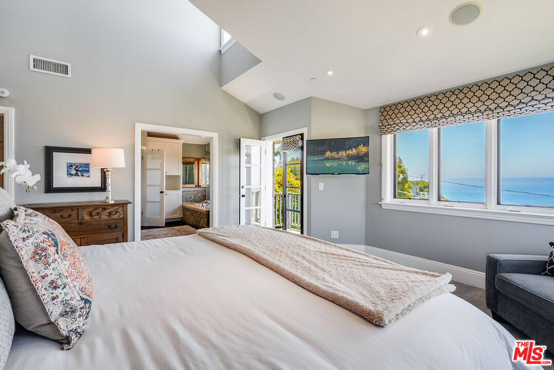 2962 Valmere Drive Malibu, CA 90265 - Photo 25 of 42 a bedroom with a large bed and a couch