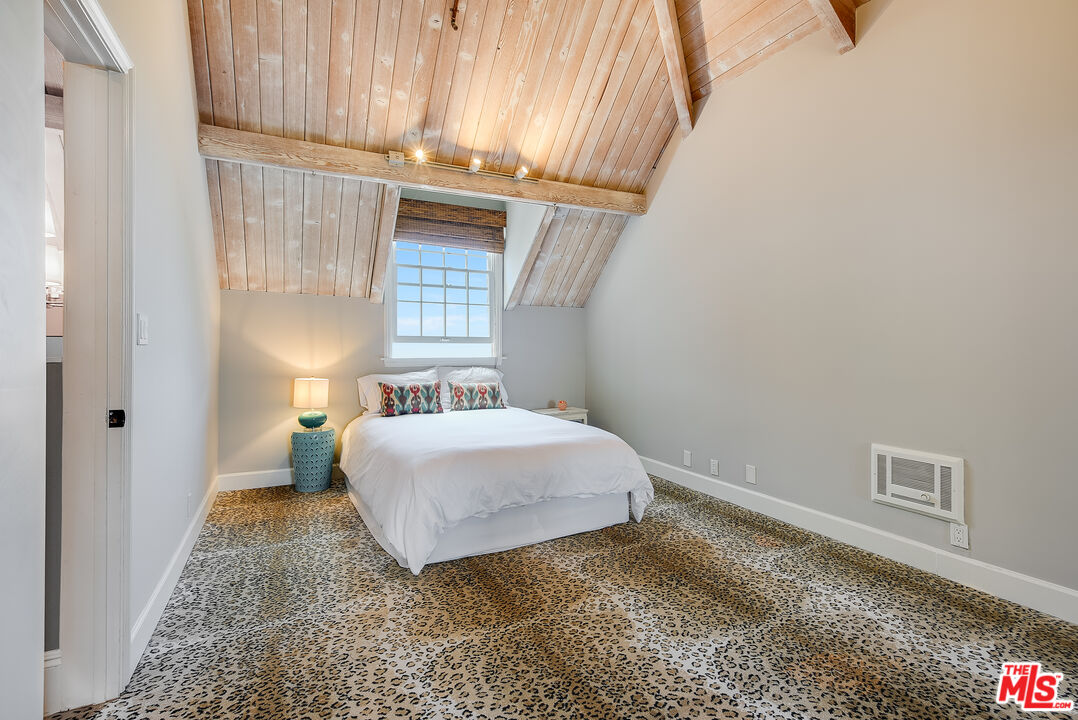 2962 Valmere Drive Malibu, CA 90265 - Photo 30 of 42 a bedroom with a bed and a window