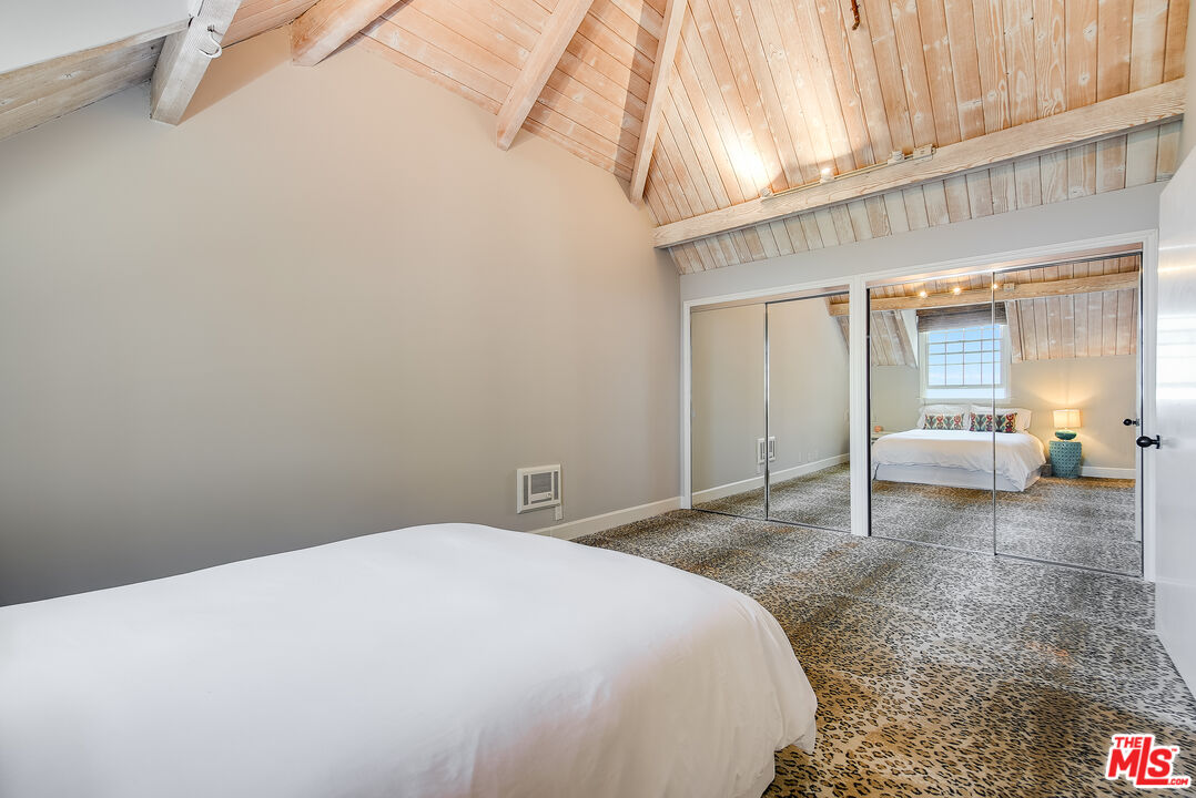 2962 Valmere Drive Malibu, CA 90265 - Photo 31 of 42 a bedroom with a bed and a mirror