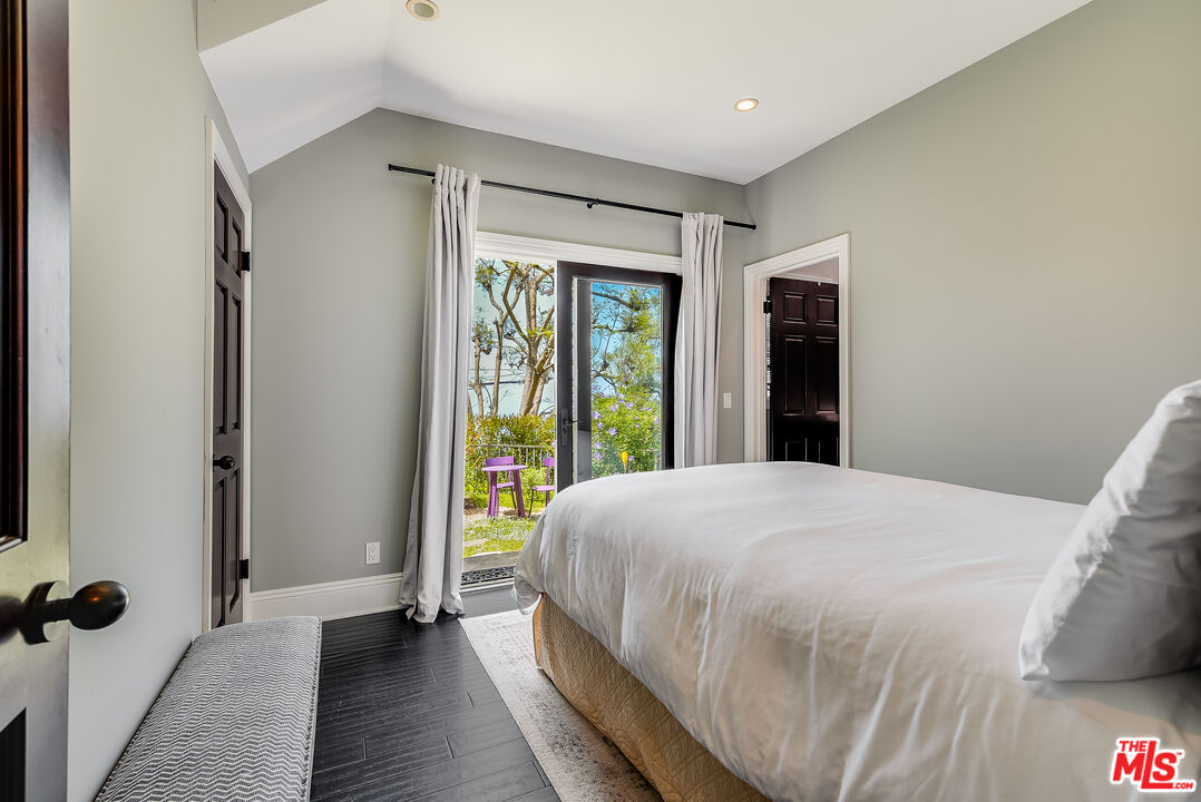 2962 Valmere Drive Malibu, CA 90265 - Photo 35 of 42 a bedroom with a bed and a large window