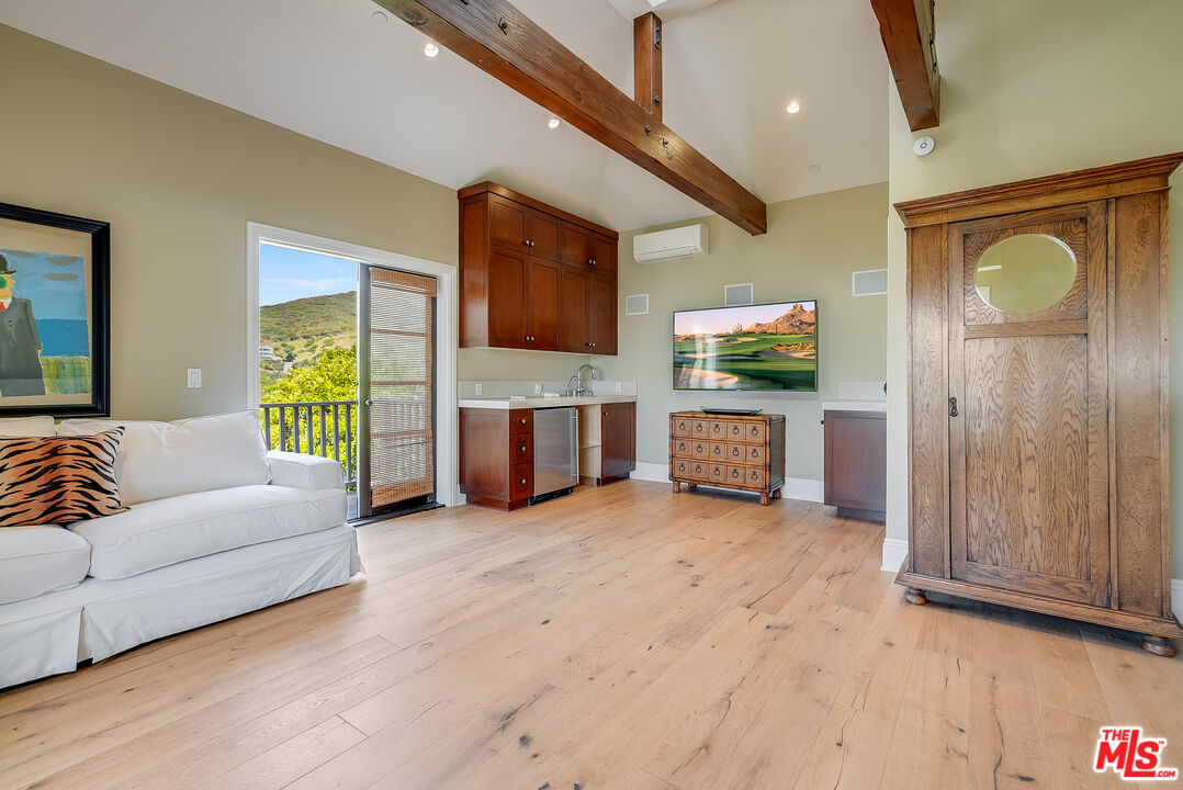 2962 Valmere Drive Malibu, CA 90265 - Photo 37 of 42 a living room with furniture and a flat screen tv