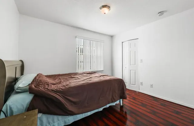 a bed sitting in a bedroom next to a window