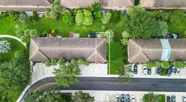 an aerial view of a house with a yard and garden