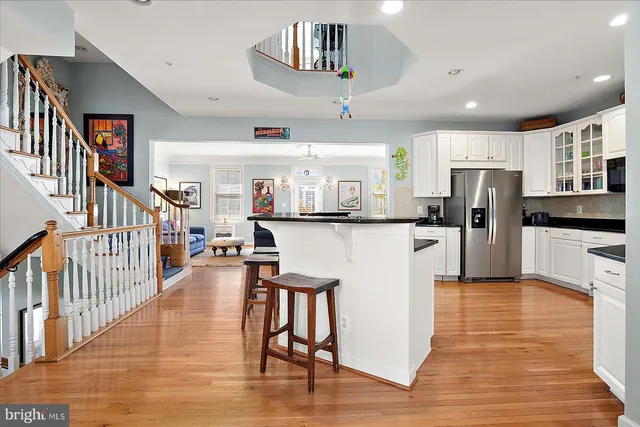 a bedroom with a bed and a lamp on dresser