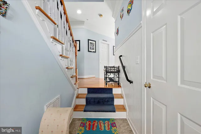a view of entryway and hall with wooden floor