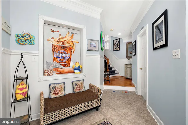 a kitchen with stainless steel appliances granite countertop a refrigerator a stove top oven a sink dishwasher and white cabinets with wooden floor