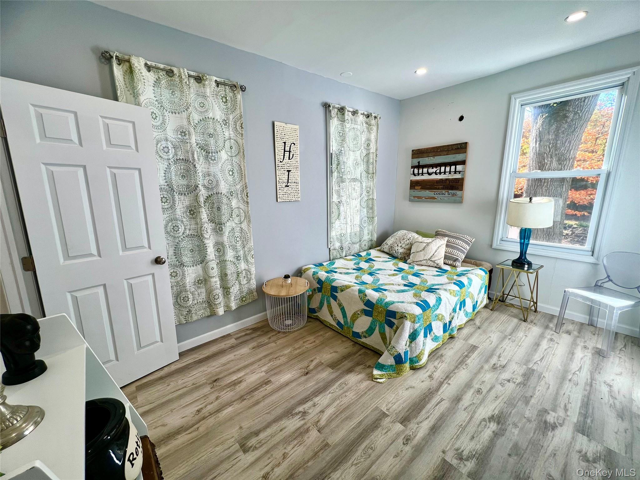 126 West Main Street, Unit 1 Middletown, NY 10940 - Photo 12 of 29 a bedroom with a bed a couch and a window