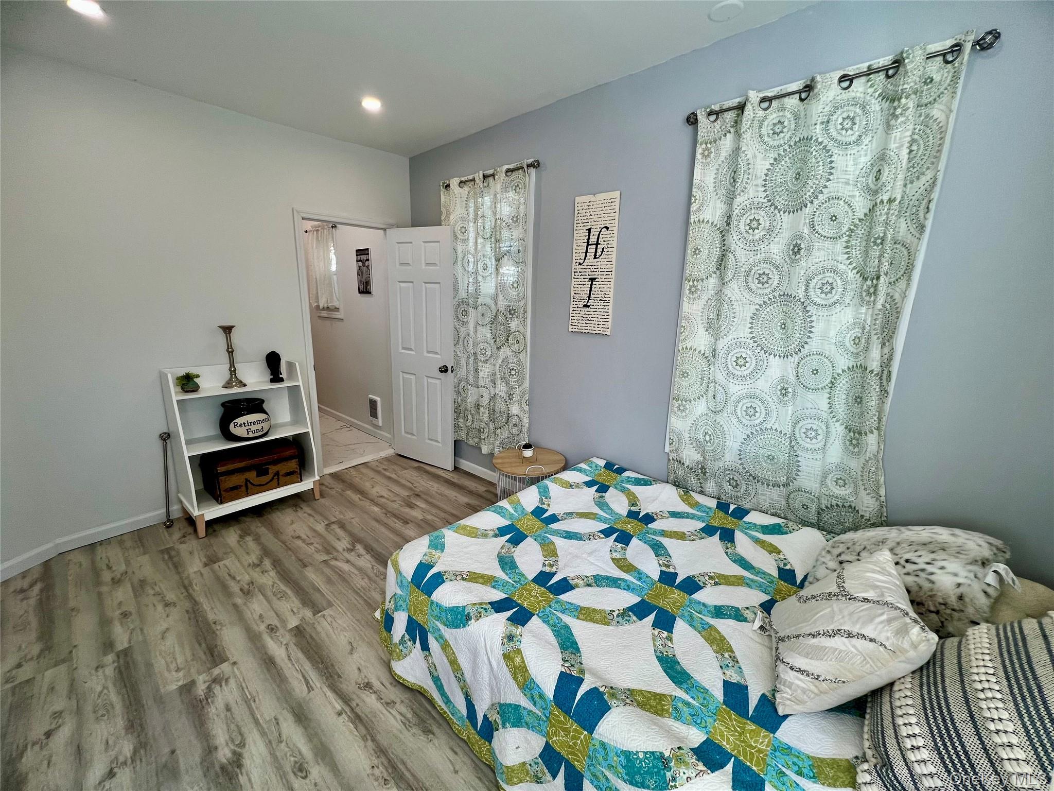 126 West Main Street, Unit 1 Middletown, NY 10940 - Photo 13 of 29 a bedroom with a bed and a chair