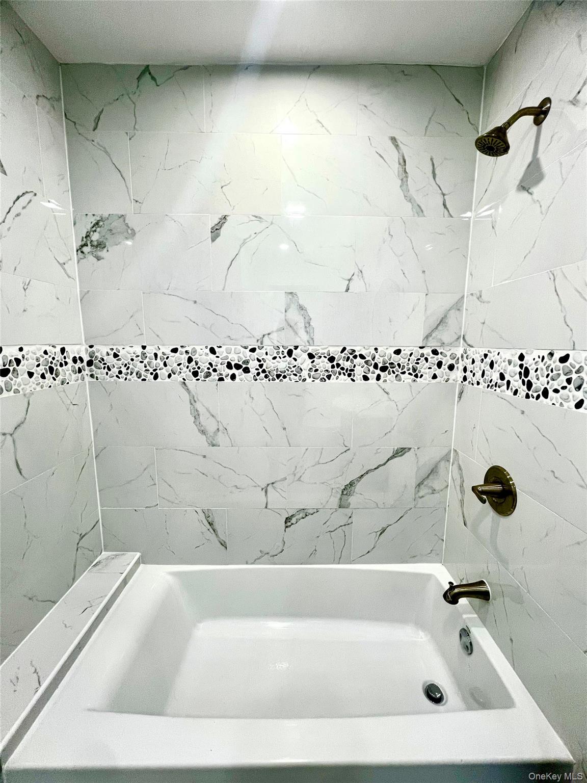 126 West Main Street, Unit 1 Middletown, NY 10940 - Photo 26 of 29 a bathroom with a bathtub and shower