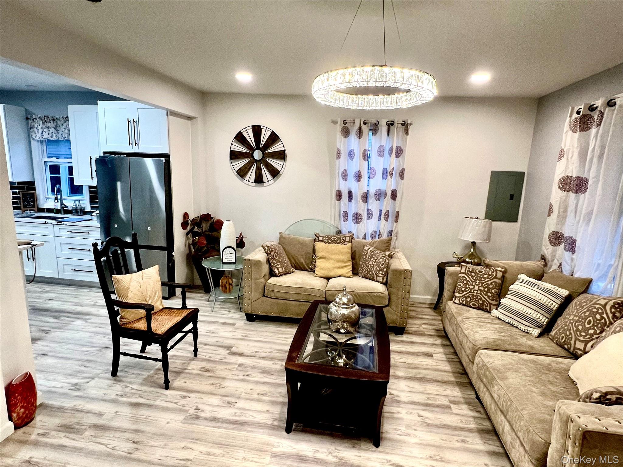 126 West Main Street, Unit 1 Middletown, NY 10940 - Photo 3 of 29 a living room with furniture a table and a flat screen tv