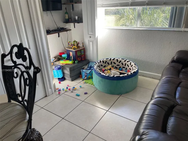a living room with furniture and a floor to ceiling window
