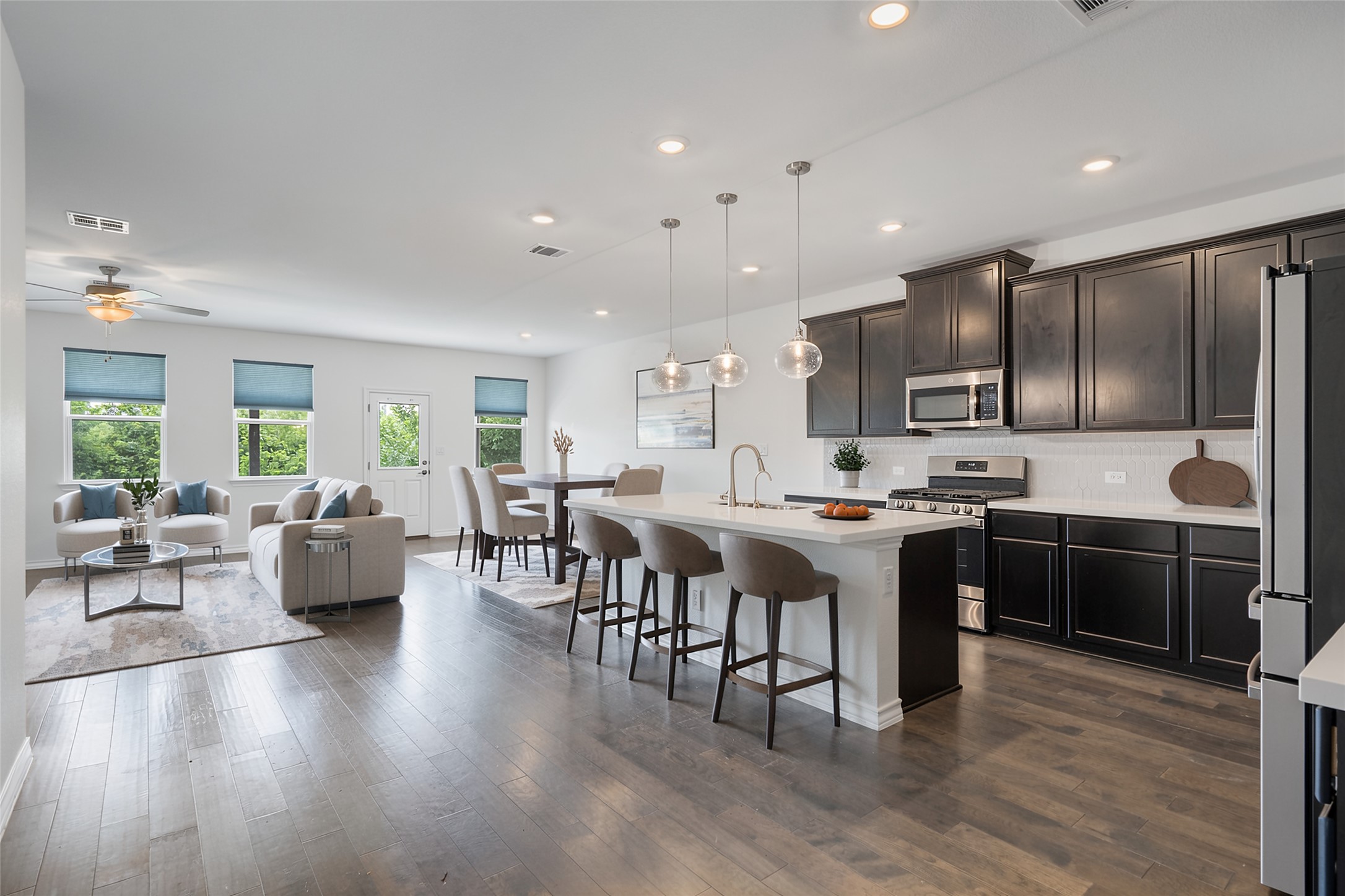 104 Stinchcomb Road Hutto, TX 78634 - Photo 7 of 40 The open-concept kitchen, dining, and living area is designed for easy connection and everyday living.