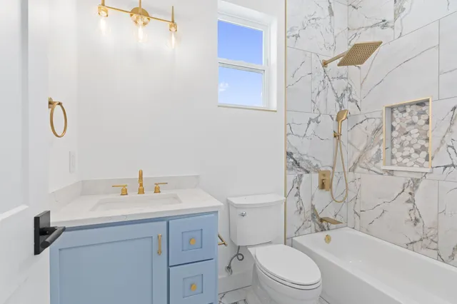 a bathroom with a sink toilet and shower