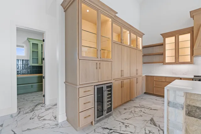 a kitchen with stainless steel appliances kitchen island granite countertop a refrigerator and a sink