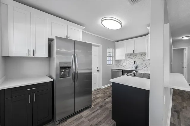 a kitchen with a refrigerator and a sink