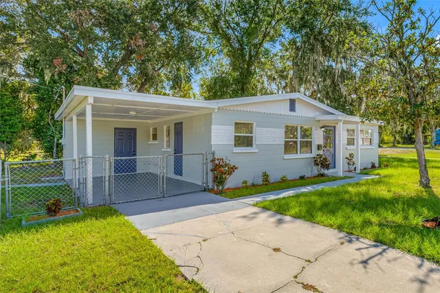 a view of an house with backyard space and garden