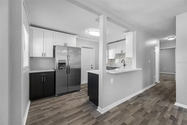 a kitchen with stainless steel appliances a refrigerator and a sink