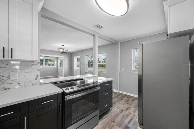a kitchen with stainless steel appliances granite countertop a sink and a stove