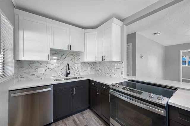 a kitchen with a sink stove and cabinets