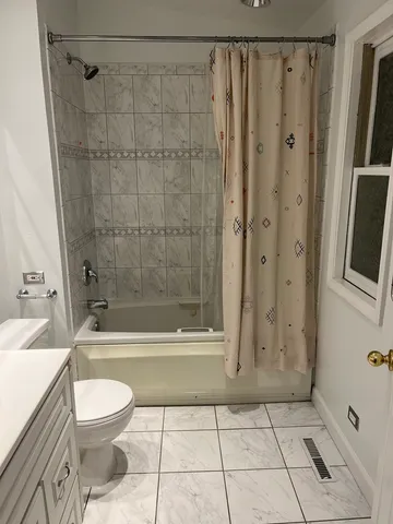 a bathroom with a toilet a sink and shower