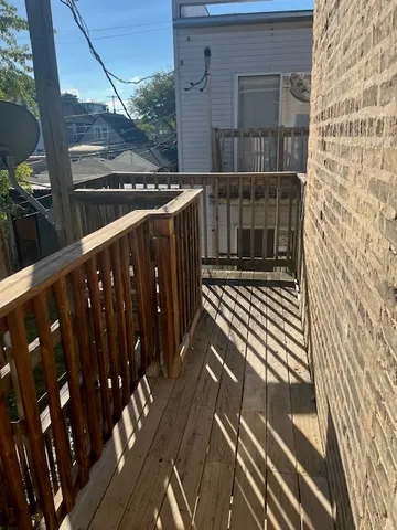 a view of balcony with wooden floor
