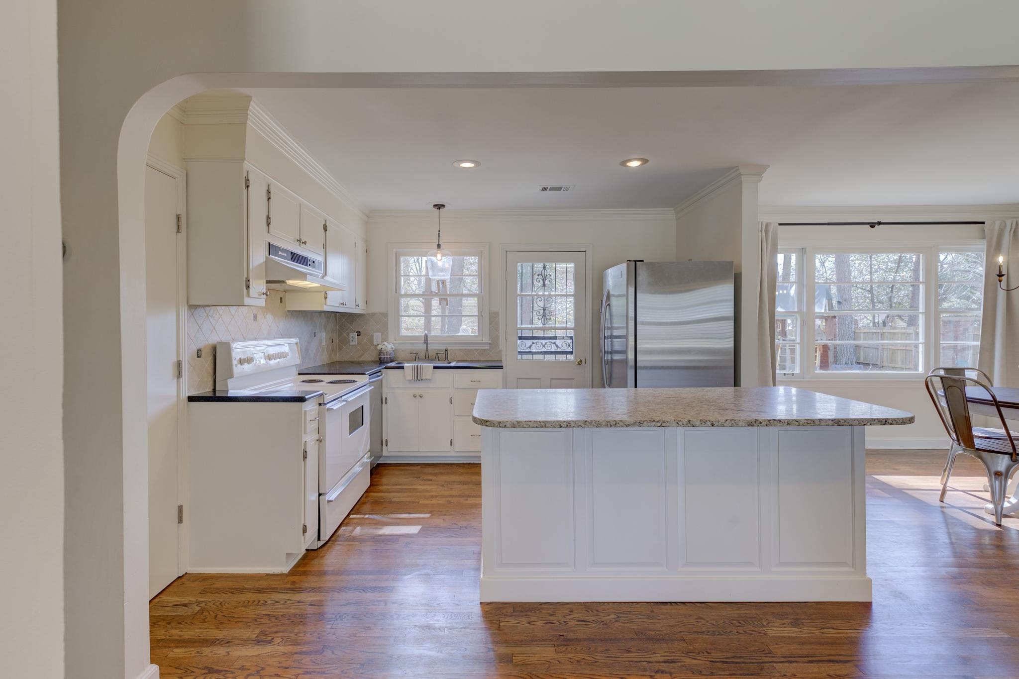 4945 Cole Road Memphis, TN 38117 - Photo 10 of 25 a large kitchen with granite countertop a large counter top stainless steel appliances and a large window