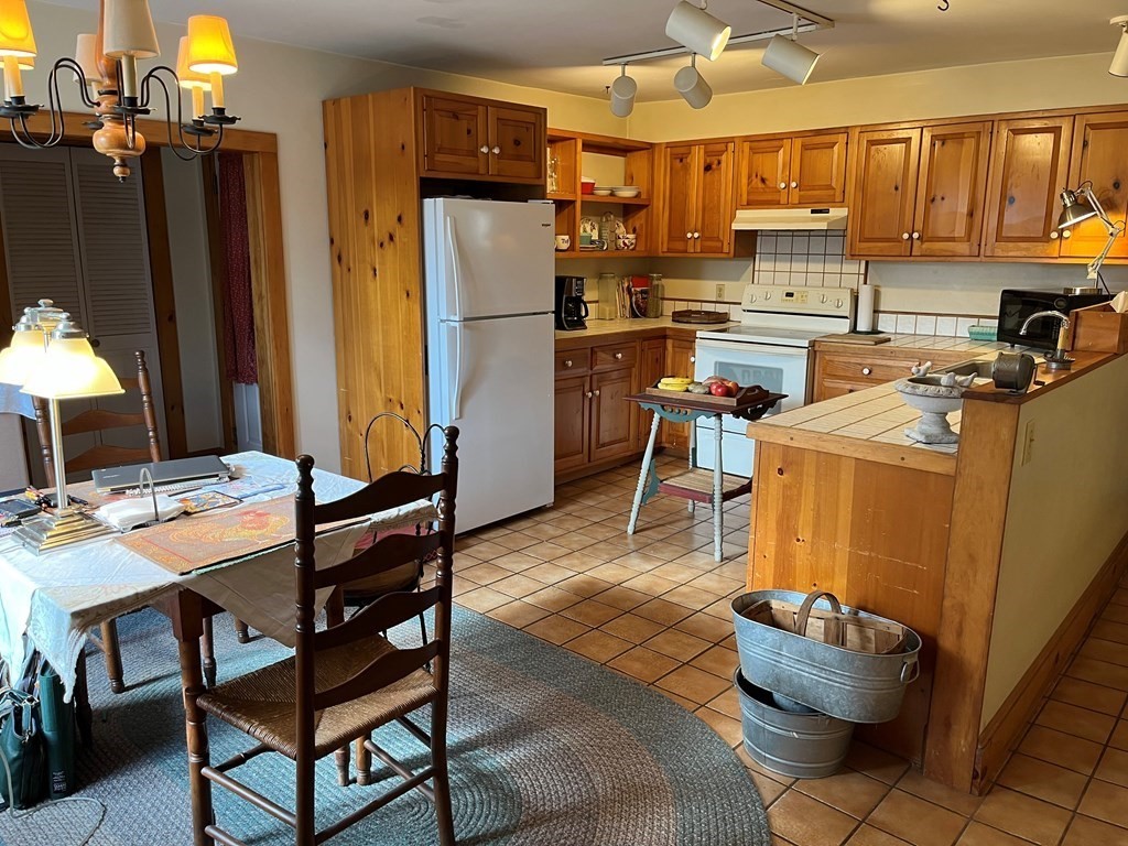 258 Chestnut Street Rehoboth, MA 02769 - Photo 4 of 34 a kitchen with a refrigerator and a table