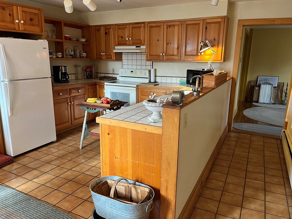 258 Chestnut Street Rehoboth, MA 02769 - Photo 8 of 34 a kitchen with stainless steel appliances a refrigerator sink and wooden cabinets