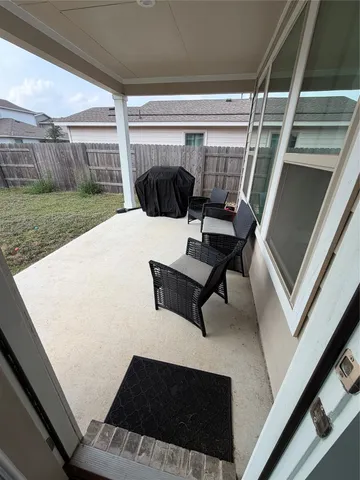 a view of a house with backyard and porch