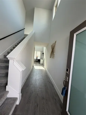 a view of hallway with wooden floor