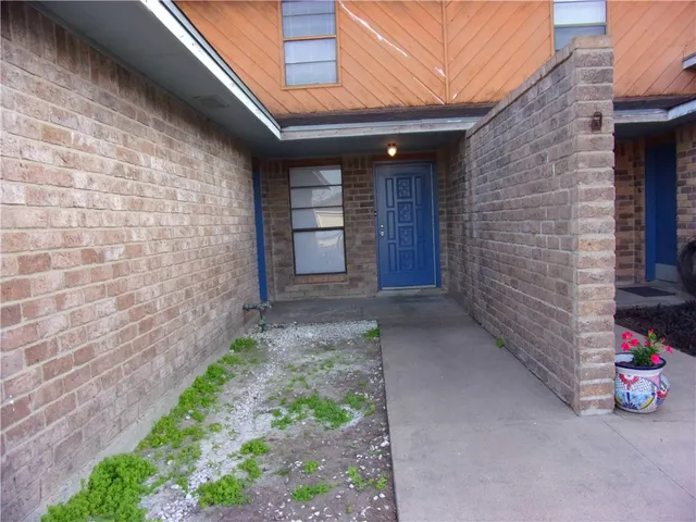 a view of front door of a house with an window
