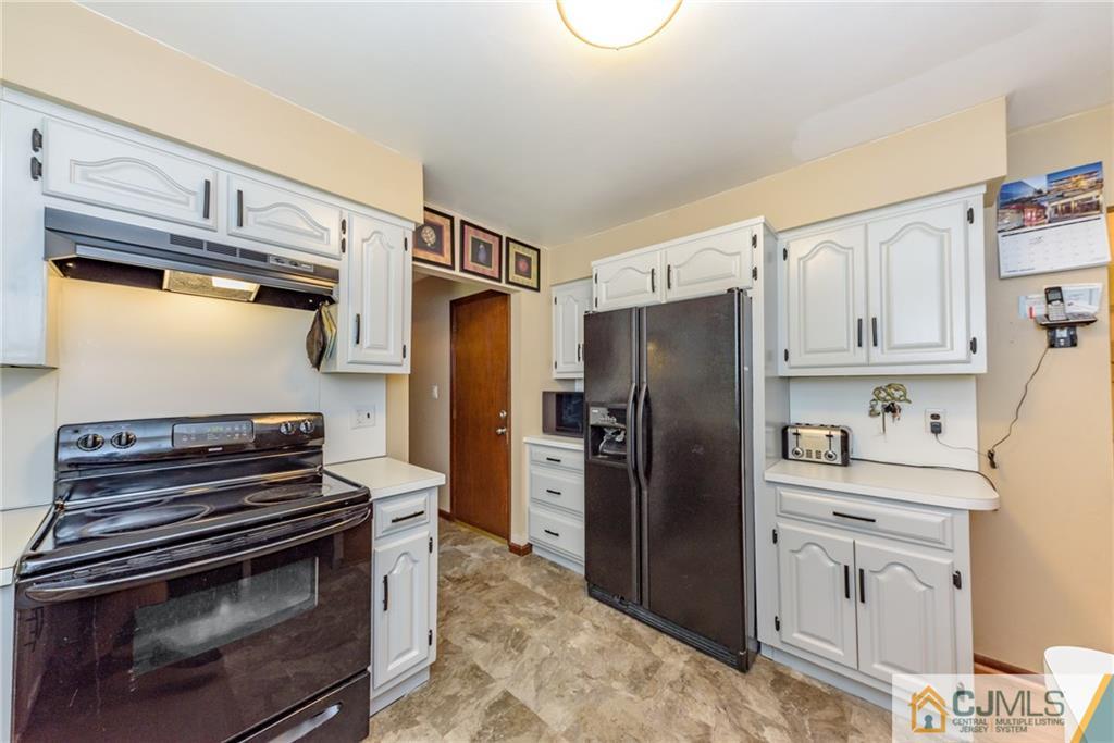 104 North Hope Chapel Road Jackson, NJ 08527 - Photo 14 of 40 a kitchen with stainless steel appliances a stove a refrigerator and cabinets