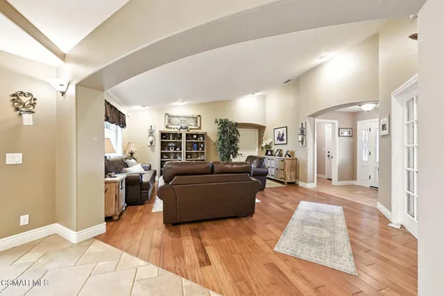 a living room with furniture and a dining table with kitchen view