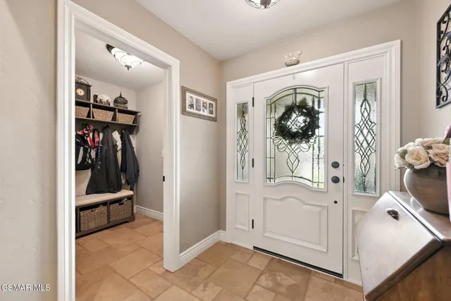 a dining hall view with a large dining table and a large window