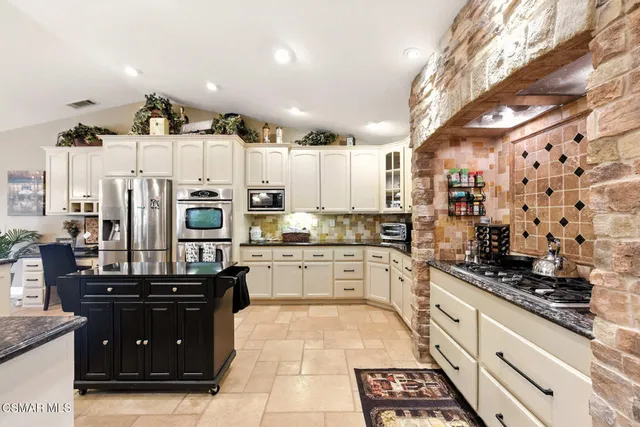 a kitchen with a sink stove and refrigerator