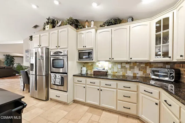 a bathroom with a sink vanity granite and a mirror