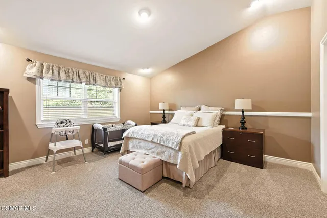 a view of a patio with couches and table and chairs under an umbrella