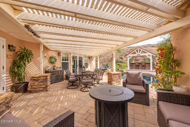 a front view of a house with a garden and trees
