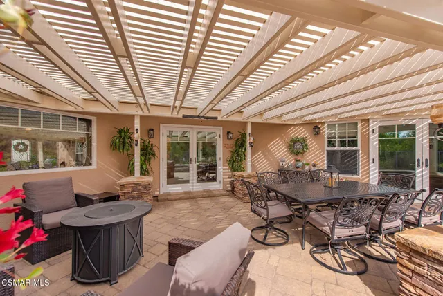 an aerial view of residential house with outdoor space and trees all around