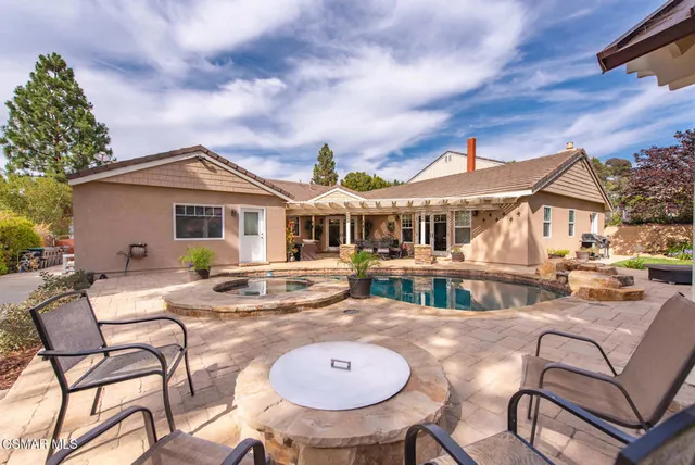 an aerial view of residential house with outdoor space and swimming pool