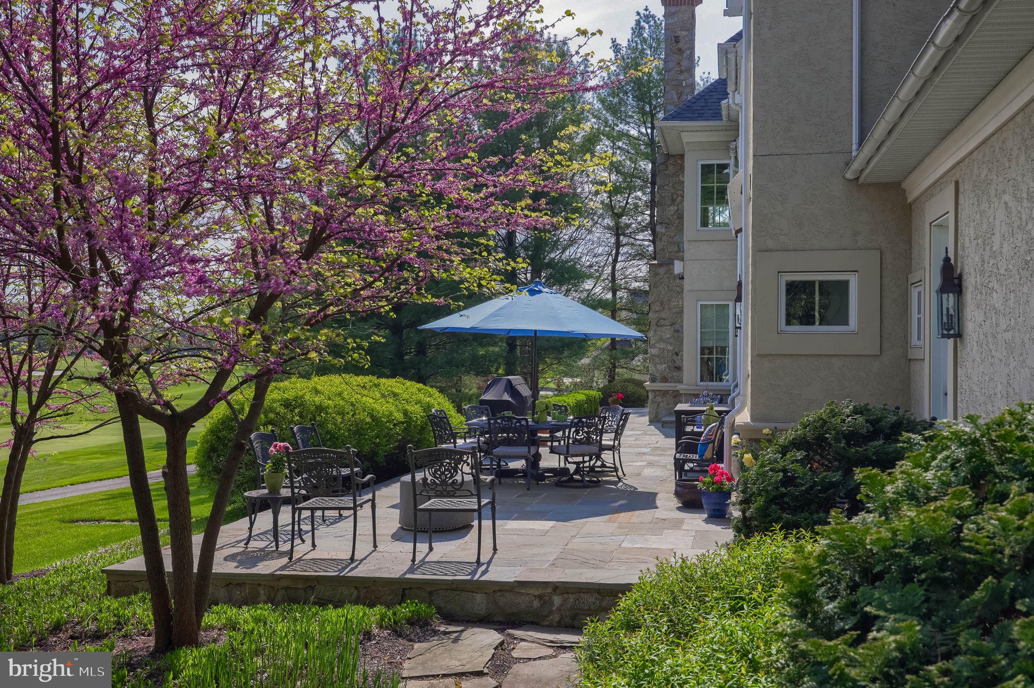 905 Greenside Drive Lititz, PA 17543 - Photo 109 of 127 a patio with a table and chairs under an umbrella