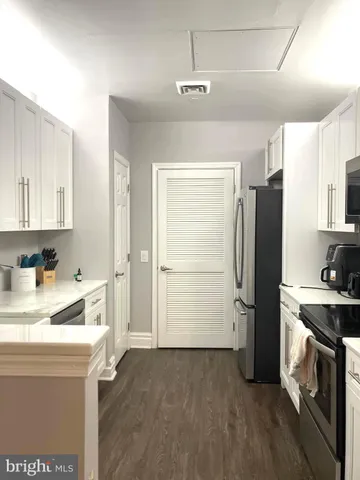 a kitchen with a refrigerator and a sink