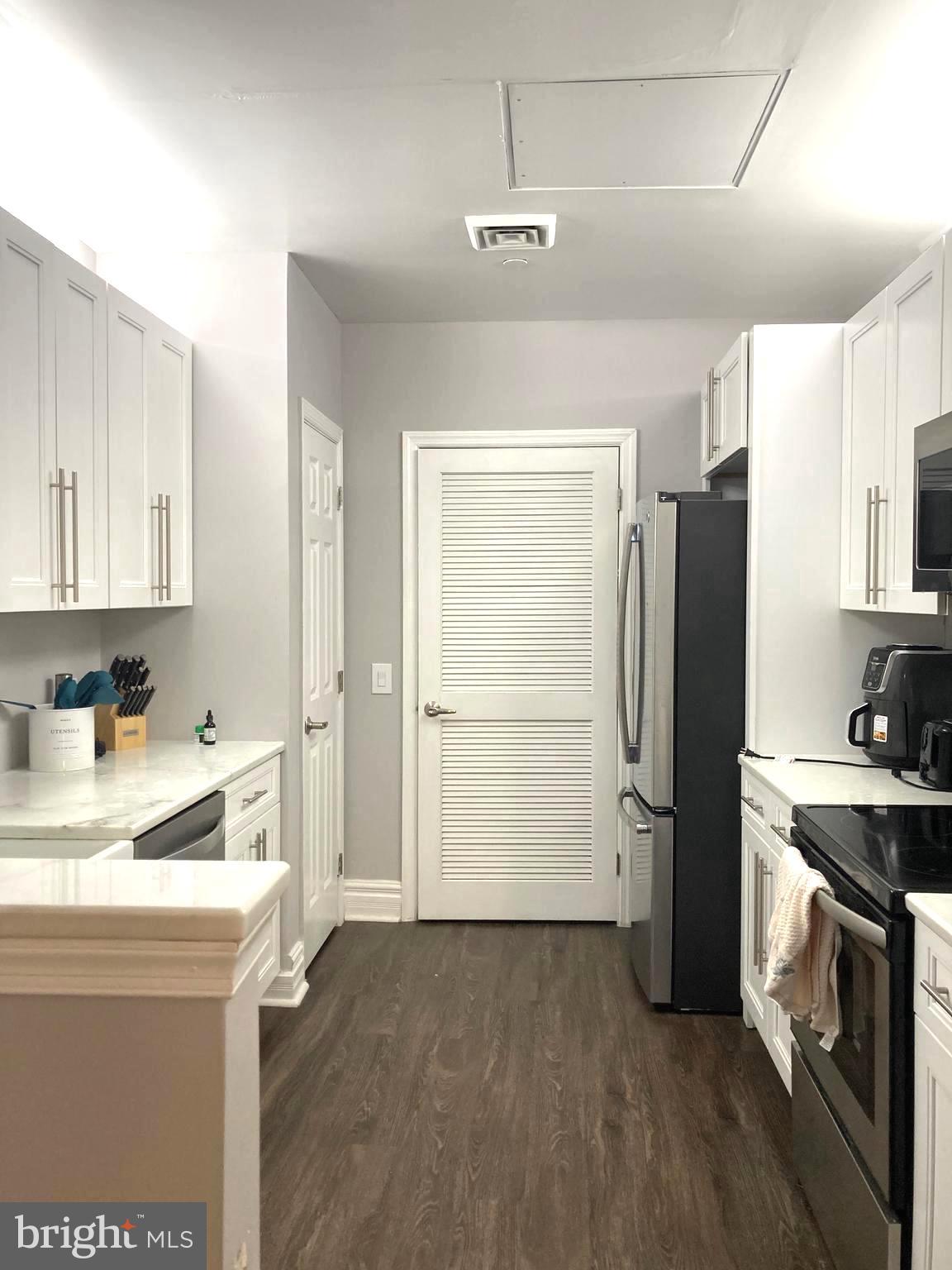 1600-18 Arch Street, Unit 1013 Philadelphia, PA 19103 - Photo 2 of 31 a kitchen with a refrigerator and a sink