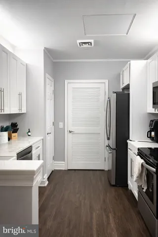 a kitchen with a refrigerator and a sink