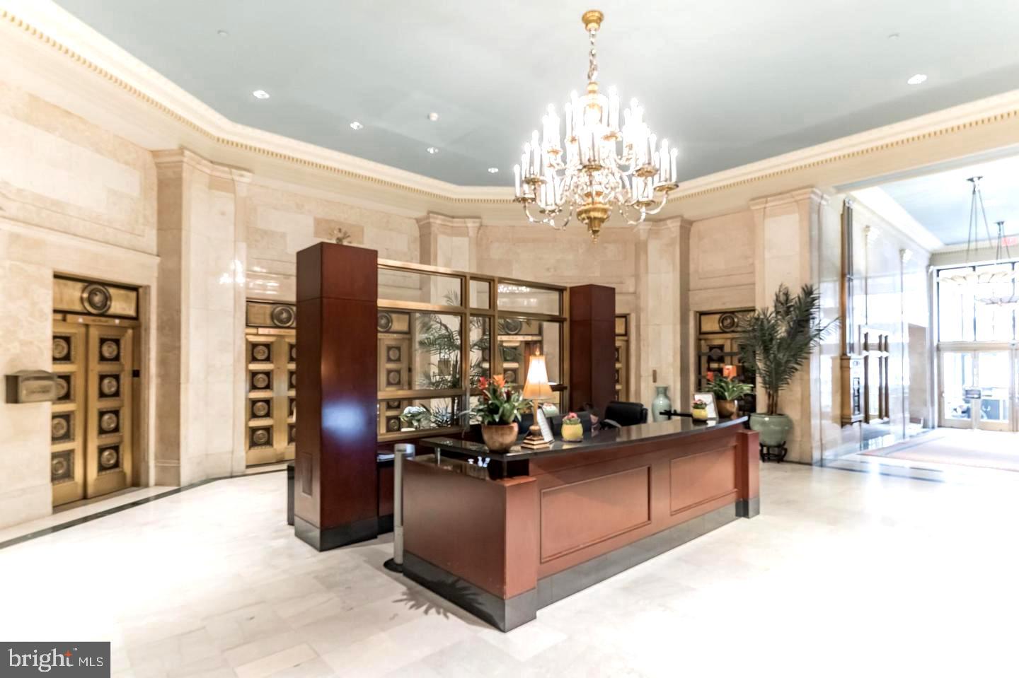 1600-18 Arch Street, Unit 1013 Philadelphia, PA 19103 - Photo 30 of 31 a living room with fireplace furniture and a chandelier