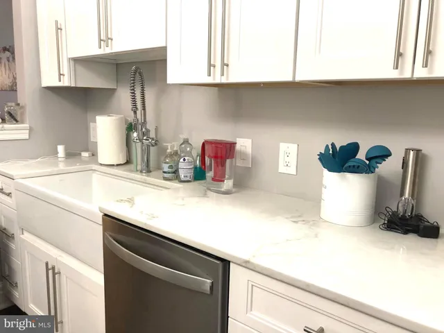 a kitchen with a sink cabinets and appliances