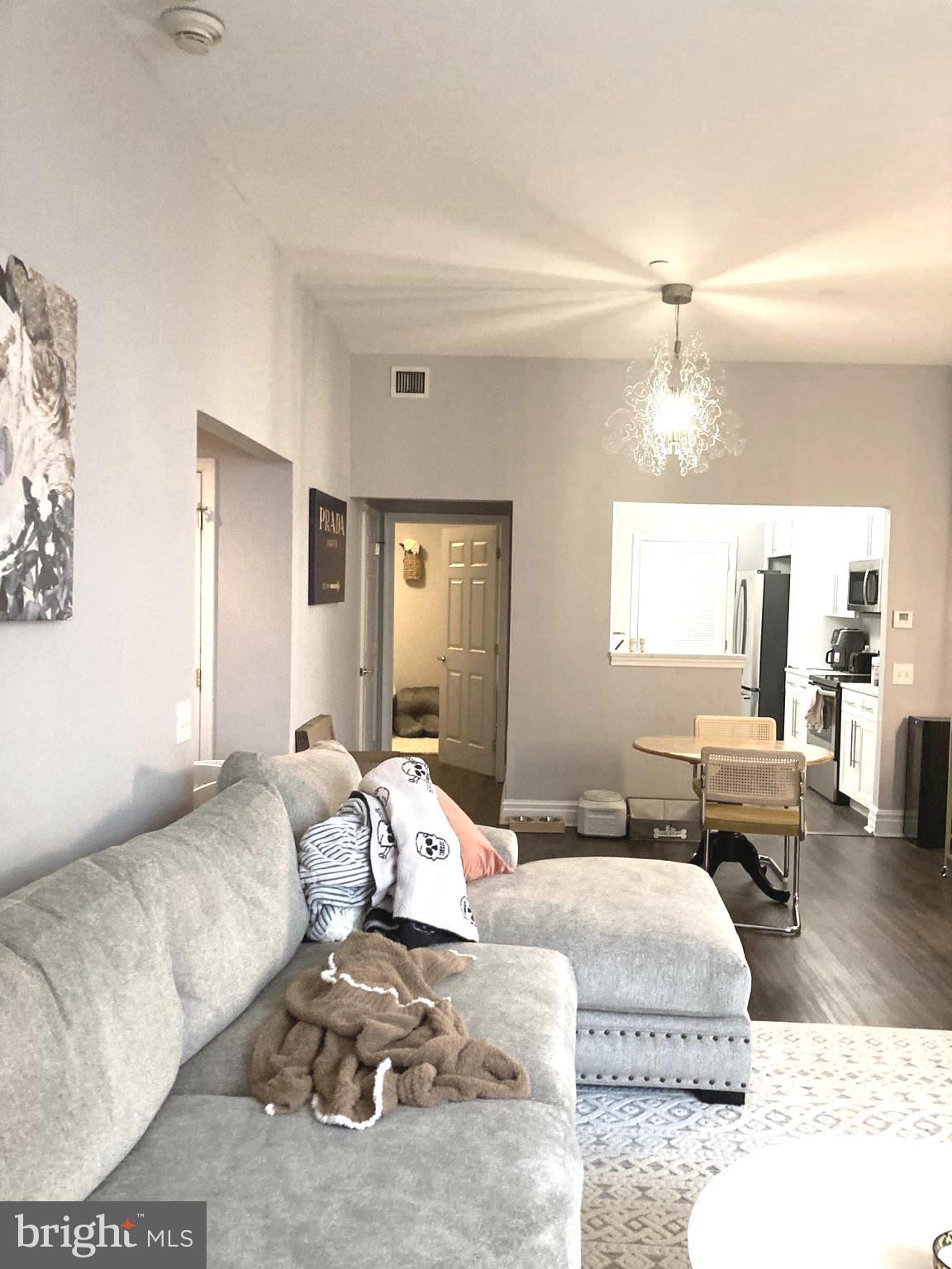 1600-18 Arch Street, Unit 1013 Philadelphia, PA 19103 - Photo 4 of 31 a bedroom with a bed couch and wooden floor